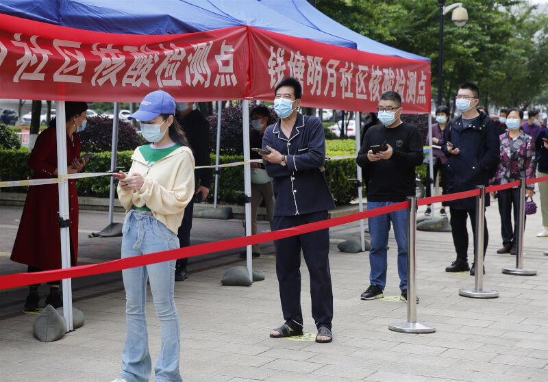 圖為杭州社區居民28日排隊採檢。（中新社）