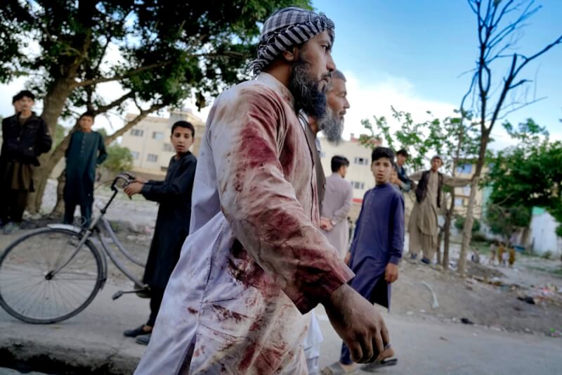 伊斯蘭國29日在阿富汗首都喀布爾引爆炸彈，造成至少10名清真寺參拜者喪命。逃出的參拜者衣服沾染大片血跡。（美聯社）