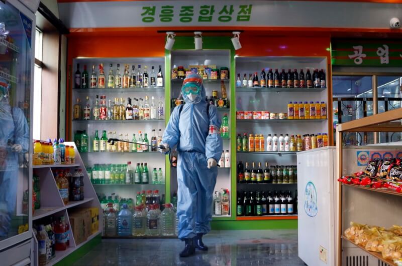 北韓通報13日新增21人「發燒」病故。圖為北韓去年11月一間零售店內消毒情況。（美聯社）