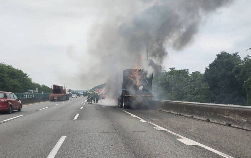 一輛載運廢紙的聯結車17日下午行經國道3號北上竹南路段,疑因油管破裂引發火勢,火舌伴隨濃煙四散瀰漫,不時傳出爆裂聲響,消防局獲報立即到場灌救。(民眾提供)中央社記者管瑞平傳真 111年5月17日