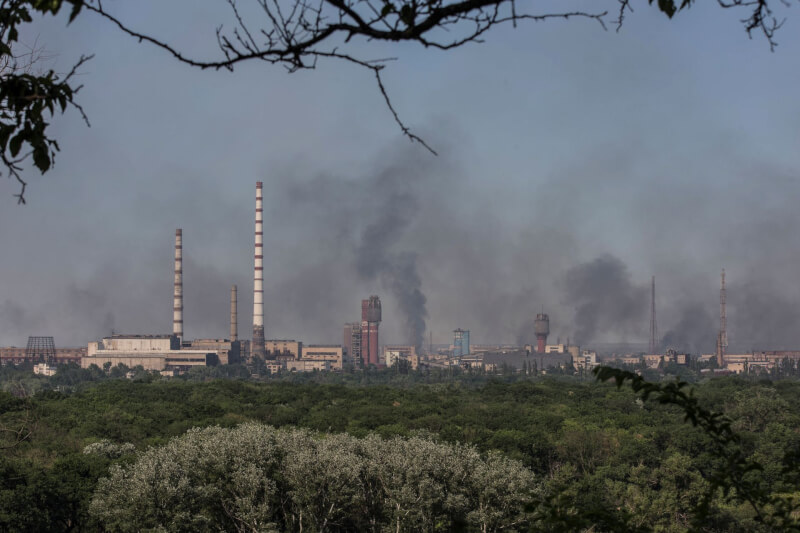 俄羅斯宣布15日起開設人道走廊，讓躲避烏國北頓內茨克阿佐特化工廠內的平民得以撤離。圖為化工廠10日遭俄軍空襲冒出濃煙。（路透社）