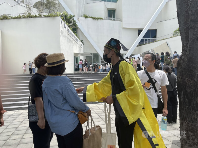 台南市美術館2館「亞洲的地獄與幽魂」25日開展,場館內外擠爆,還有人穿著道士服發放符咒安人心。中央社記者張榮祥台南攝 111年6月25日
