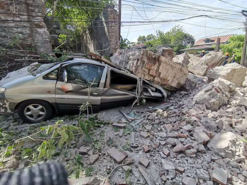一輛車遭倒塌建物壓毀。(圖取自facebook.com/DILGBFP)