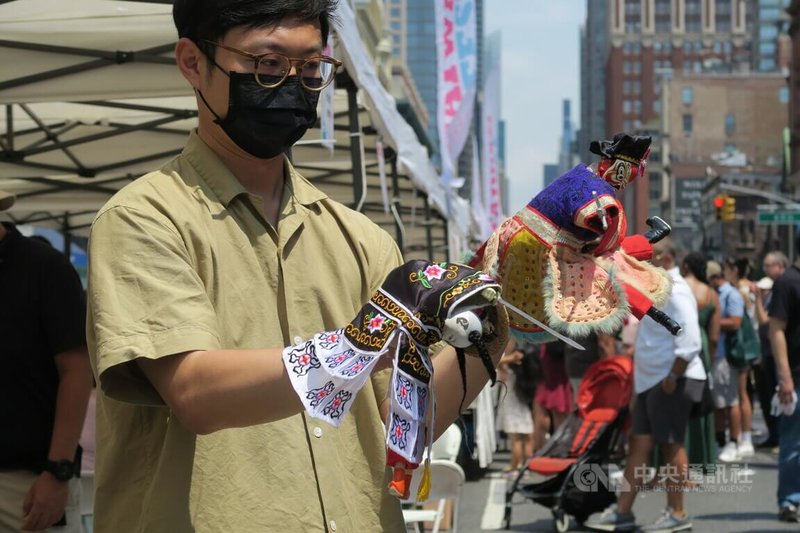 台北偶戲館館長蔡易衛為自己與父母圓夢，今年夏季把台灣布袋戲帶到紐約街頭。圖為蔡易衛7月16日在曼哈頓的台灣市集操演戲偶。中央社記者尹俊傑紐約攝  111年8月1日