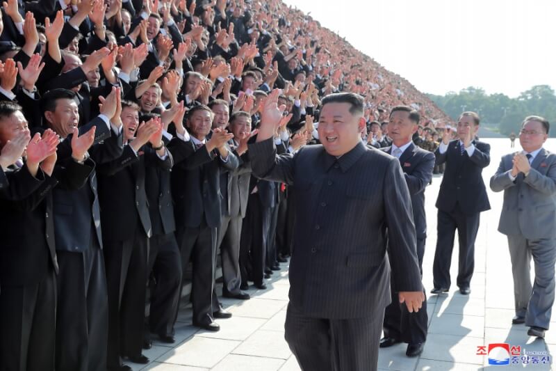 北韓領導人金正恩（前中）宣布戰勝疫情，已取消強制戴口罩和保持社交距離等防疫規定。圖為10日金正恩和全國緊急防疫會議與會者合影。（圖取自北韓中央通信社網頁kcna.kp）