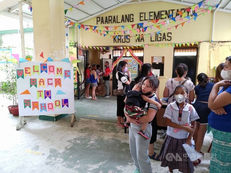 菲律賓中小學新學年22日開學。圖為菲國學生和家長在馬尼拉都會區奎松市一所小學辦理相關手續。中央社記者陳妍君馬尼拉攝  111年8月22日
