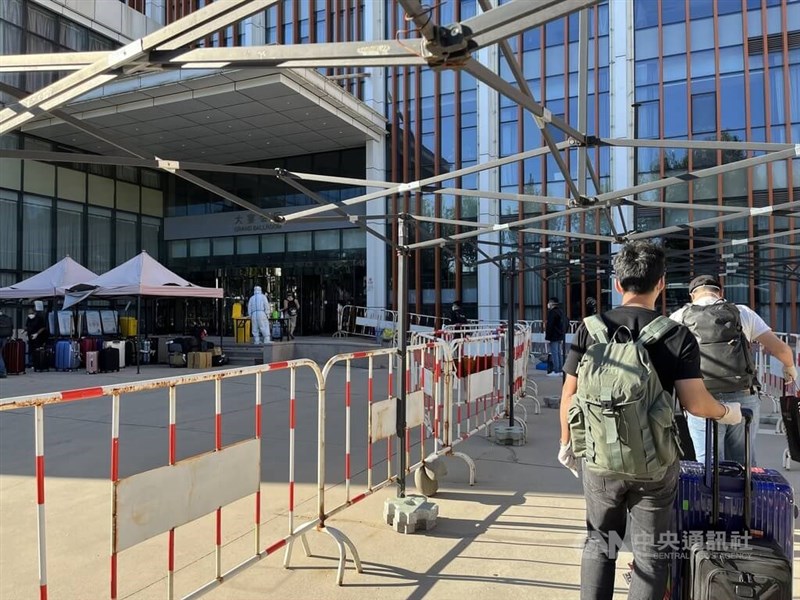 中國執行疫情清零政策。旅客搭乘飛機抵達北京後，跑完系列核酸檢測流程隨即進入閉環管理模式，由運輸大巴士轉運到隨機分派的隔離酒店。圖為旅客等待進入隔離酒店。中央社記者李雅雯北京攝 111年9月21日