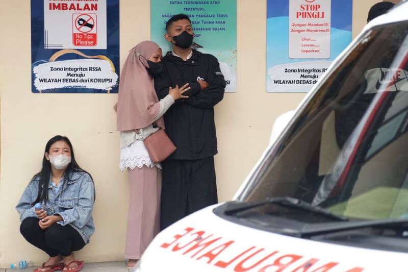 印尼東爪哇省瑪琅市足球賽踩踏事件的死亡人數下修至125人。圖為事發後家屬等待確認罹難者身分。（路透社）