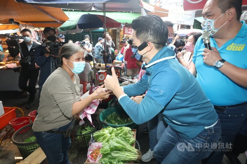 國民黨台北市長參選人蔣萬安（右2）14日上午在士林區社子市場掃街，和民眾握手致意，爭取選票支持。中央社記者吳家昇攝  111年10月14日