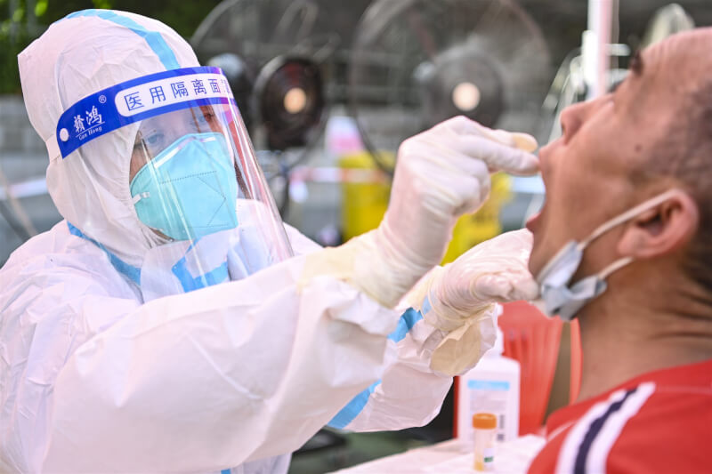 圖為4月醫護人員在廣州海珠區為市民做核酸檢測。（中新社）