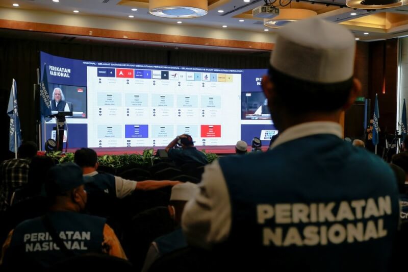 馬來西亞19日進行國會大選，前首相慕尤丁率領的國民聯盟支持者在一家飯店觀看選舉開票結果。（路透社）