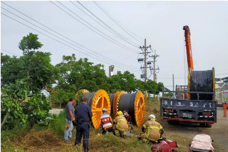 一輛有吊臂的起重工程車21日在台南市北門區作業時，疑似吊桿誤觸高壓電線導致司機觸電昏迷，沒有呼吸與心跳，救護人員到場搶救。（讀者提供）中央社記者楊思瑞攝  111年11月21日