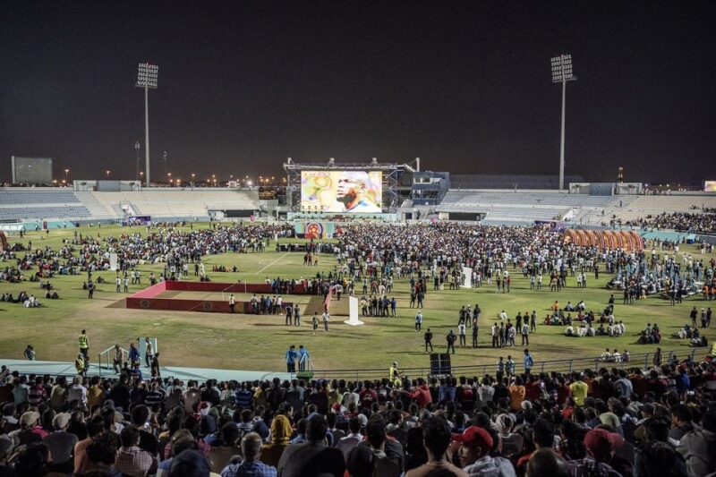 數千名移工聚集在卡達首都杜哈市郊一座特設球迷專區，欣賞中東地區的第一場世界盃足球賽開幕賽。（路透社）