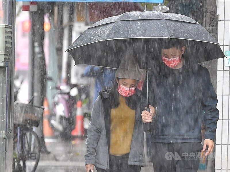 圖為台北街頭民眾撐傘避雨。（中央社檔案照片）