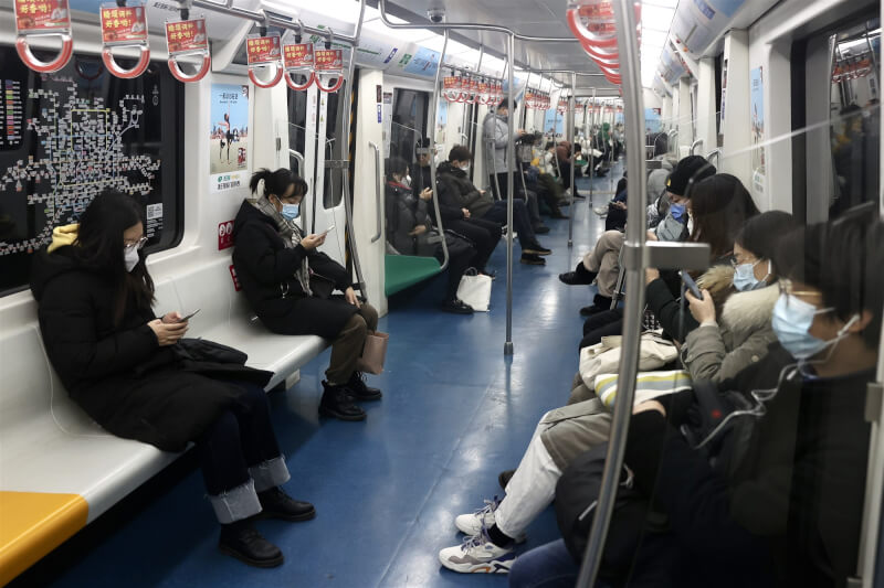 中國各地近期逐漸鬆綁嚴苛的防疫措施，至少19城宣布乘坐地鐵不再查驗核酸檢測陰性證明。圖為5日北京民眾搭乘地鐵。（中新社）