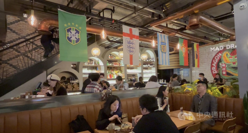 卡達世界盃賽事進行期間，上海市多家餐廳應景布置，現場拉起大螢幕、懸掛參賽隊伍國旗，營造看球熱鬧氣氛。中央社記者李雅雯上海攝 111年12月14日