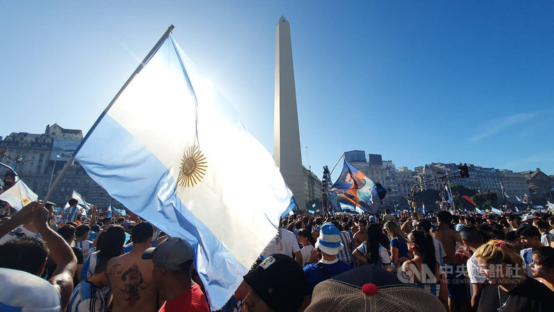 如同全球藍白足球迷期待，阿根廷摘下第3座世足賽金盃。逾百萬民眾湧現阿國首都布宜諾斯艾利斯市中心方尖碑及七九大道歡慶，國旗飄揚榮耀阿根廷。中央社記者黃韻如布宜諾斯艾利斯攝 111年12月19日