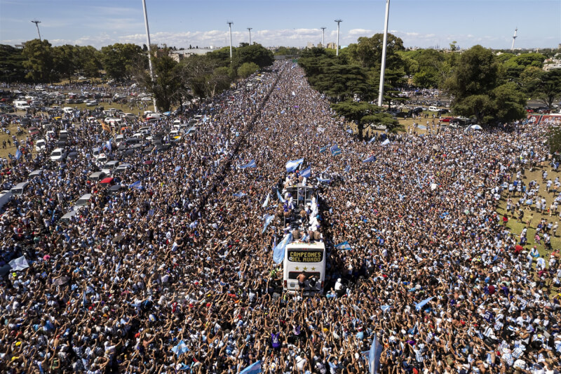 阿根廷國家隊成員20日搭巴士在首都布宜諾斯艾利斯遊行，沿途擠滿球迷。（美聯社）