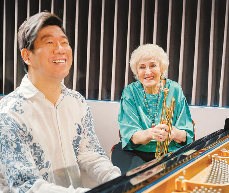 旅美知名鋼琴家劉孟捷（左）接受空中英語教室雜誌專訪，並與創辦人彭蒙惠（右）一人彈奏鋼琴、一人吹奏小喇叭，用音樂相見歡。（空中英語教室提供）中央社記者趙靜瑜傳真  112年1月7日