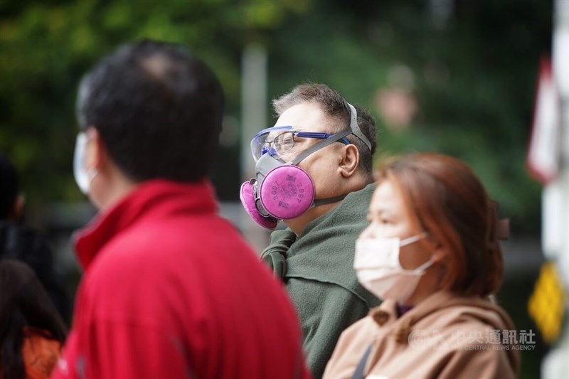 圖為在台北市中正區街頭等紅綠燈的民眾戴上面罩、口罩防疫。（中央社檔案照片）