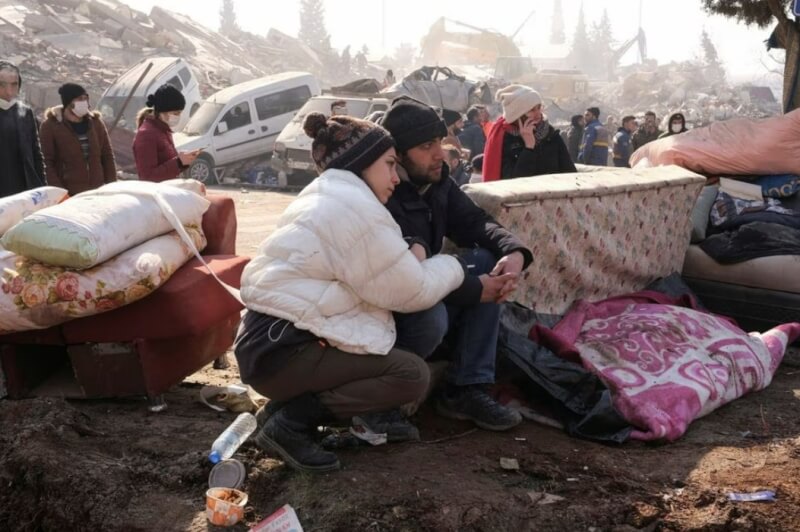 土耳其和敘利亞6日地震，已造成2萬8191人死亡。圖為11日土耳其卡拉曼馬拉斯一對夫妻在旁等待親人搜救結果。（路透社）