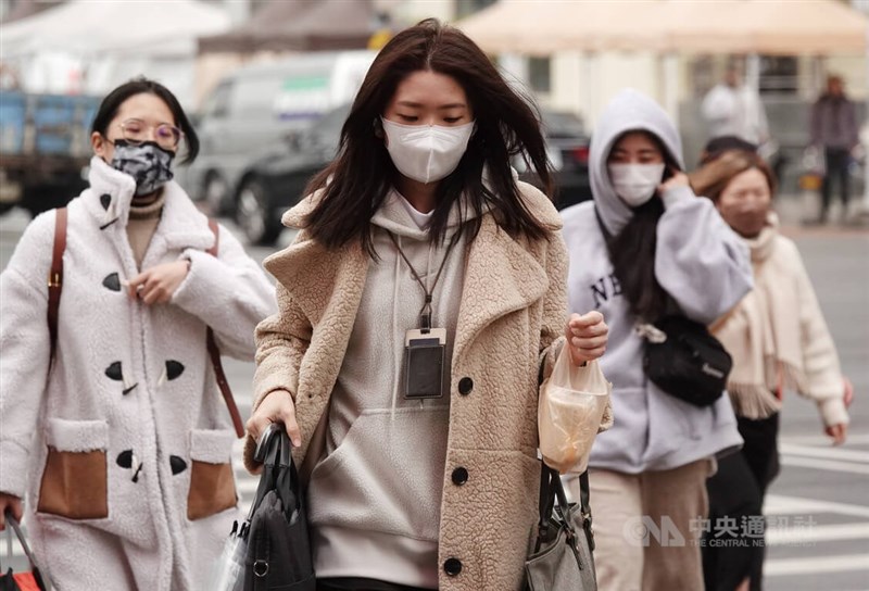 圖為台北西門町街頭民眾穿大衣禦寒。（中央社檔案照片）