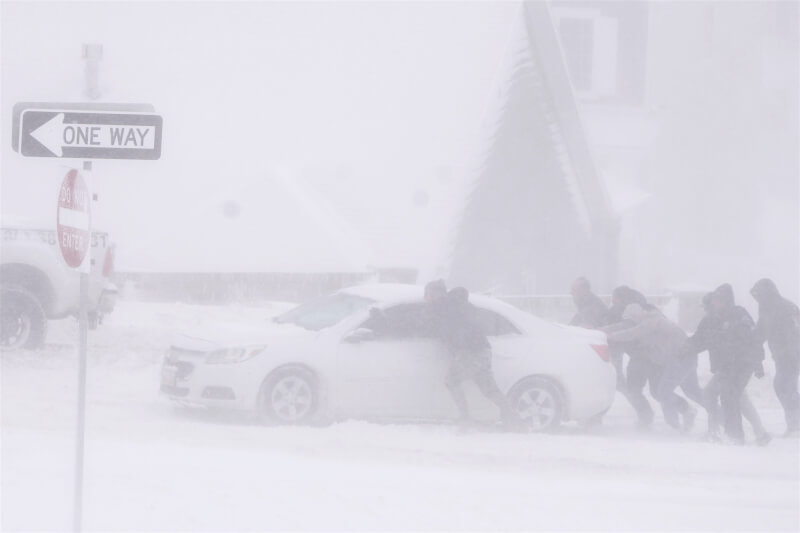 22日美國猶他州下雪，民眾將車輛推出雪地。（法新社）
