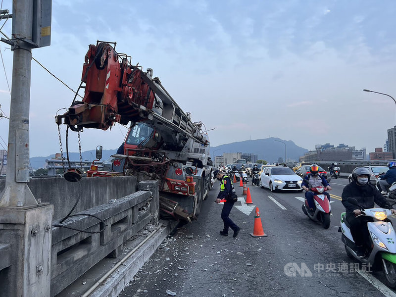 台北市內湖區成美橋21日發生一輛輪式起重機自撞事故，駕駛手部受傷、乘客擦挫傷，送醫皆無礙；駕駛向警方供稱為煞車失靈釀禍。（翻攝照片）中央社記者黃麗芸傳真  112年3月21日