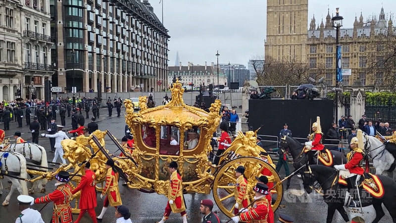 英王查爾斯三世6日於西敏寺加冕後，與王后卡蜜拉同乘君主及其配偶專用的「王室金馬車」返回白金漢宮。上一次王室慶典使用金馬車是2022年6月女王白金禧。馬車歷史可追溯至1760年，並自1831年以來，用於每次君主加冕。中央社記者陳韻聿倫敦攝 112年5月7日