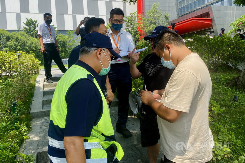 承接台積電南科廠配管工程劉姓包商因與上游包商發生糾紛,24日發動親友到台積電南科廠區外拉白布條陳情,除台積電出動保全前往關切外,警方也動員警力到場戒護。中央社記者楊思瑞攝 112年5月24日