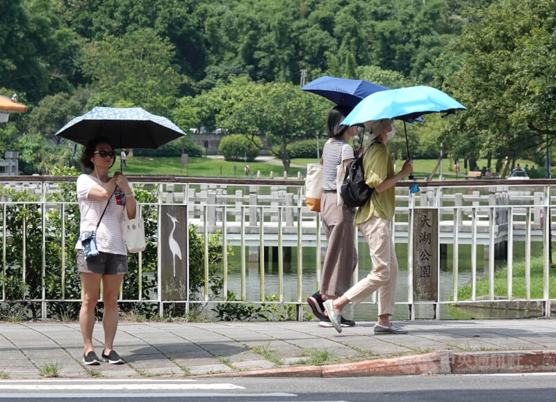 圖為大湖公園民眾撐傘遮陽。（中央社檔案照片）