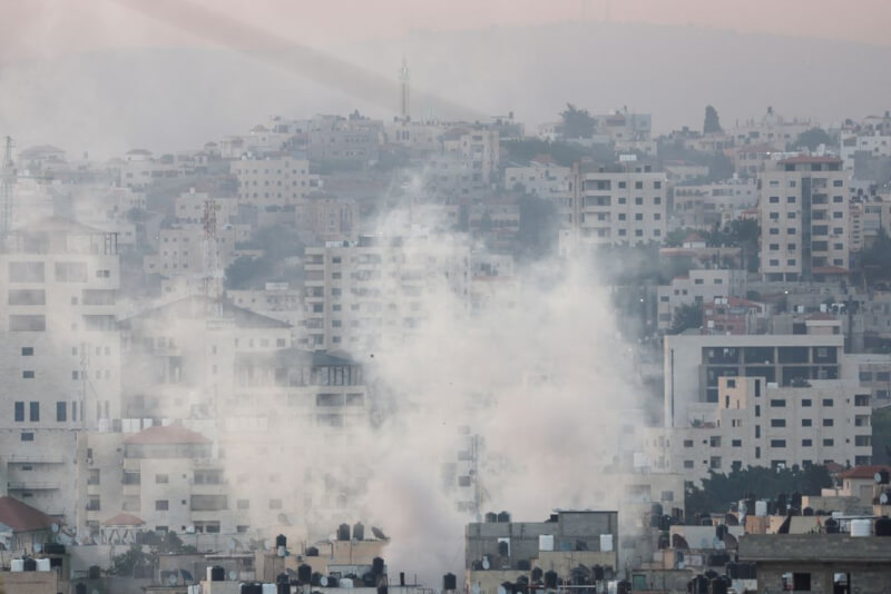 以色列軍隊連夜突襲約旦河西岸城市哲寧。圖為哲寧市區冒出濃煙。（路透社）