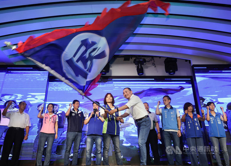 國民黨總統參選人侯友宜（前右，白衣者）9日中午出席新北市土城宜蘭同鄉會餐敘活動，現場揮舞戰旗，感謝鄉親的支持。中央社記者趙世勳攝 112年7月9日