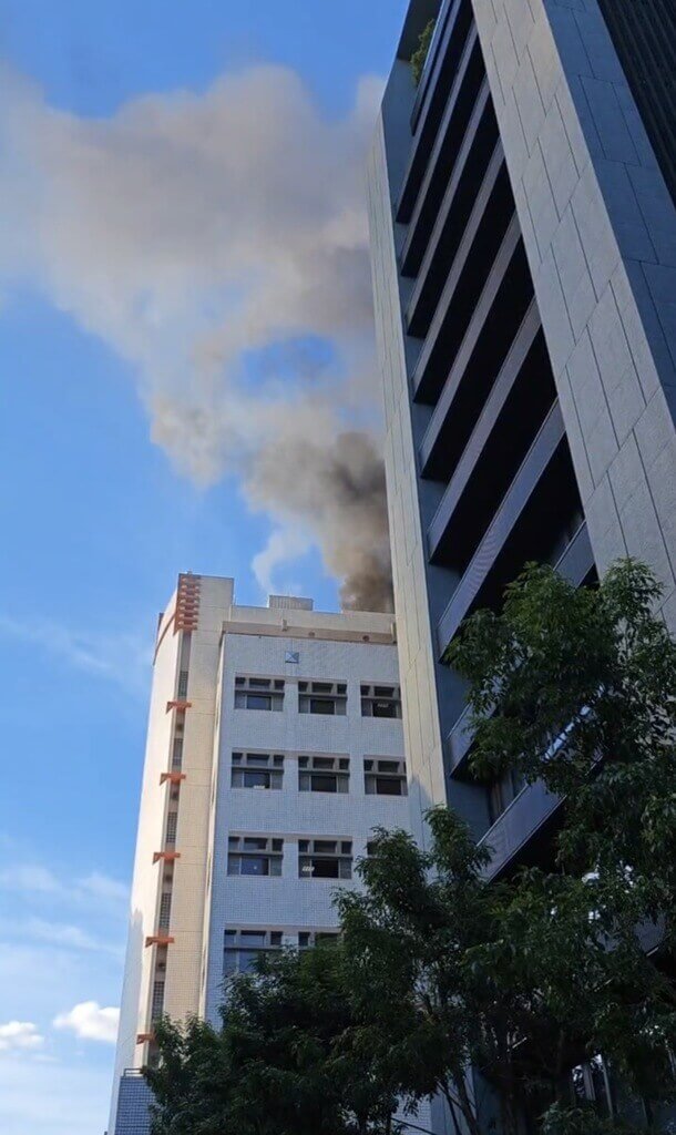 台北市警消14日獲報，信義路4段附近巷弄的中華電信研究院台北辦公室頂樓起火，疑因冷卻水塔施工釀禍，火勢在10分內控制無人受傷，詳細起火原因仍待調查釐清。（翻攝畫面）中央社記者劉建邦傳真 112年7月14日