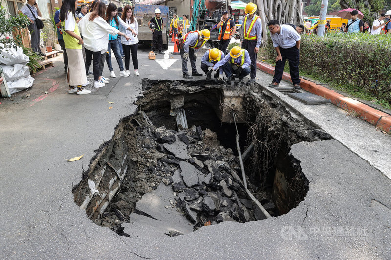 台北市大同區赤峰街附近巷弄14日路面出現坑洞。圖為工作人員查看確認坑洞情況。中央社記者謝佳璋攝 112年9月14日
