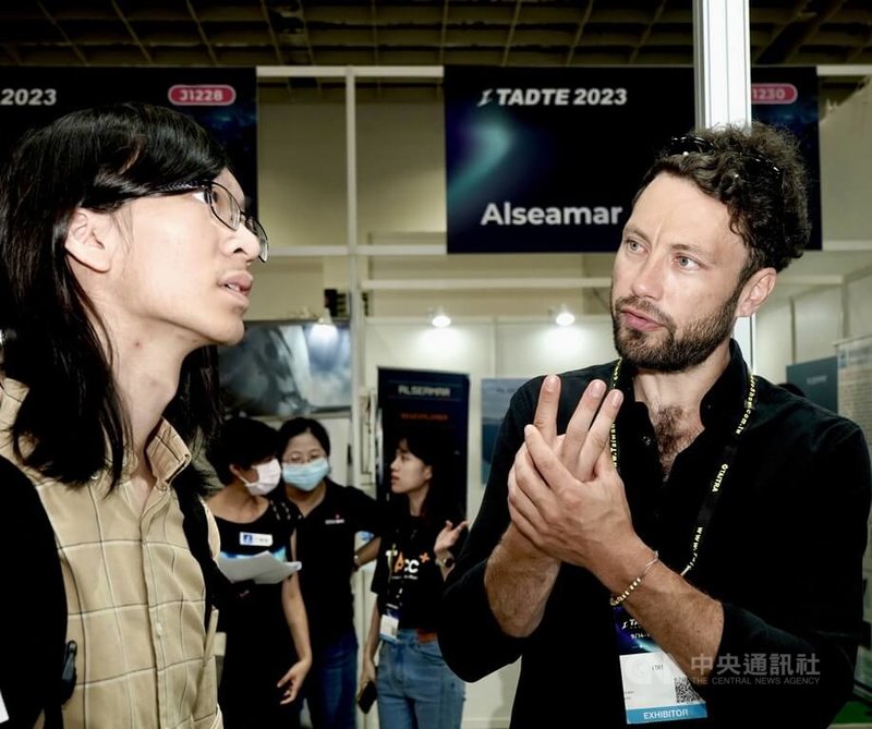 德國太空新創家普利布赫（Alex Plebuch，右）在台北國際航太暨國防工業展向與會者說明閥門、電動泵應用原理。中央社記者張璦攝  112年9月16日