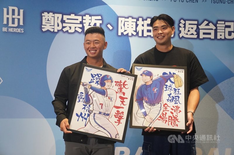 旅美職棒球員鄭宗哲（左）與陳柏毓（右）返台，20日下午在台北出席記者會，拿著經紀公司贈送的畫作接受媒體拍照。中央社記者徐肇昌攝  112年9月20日
