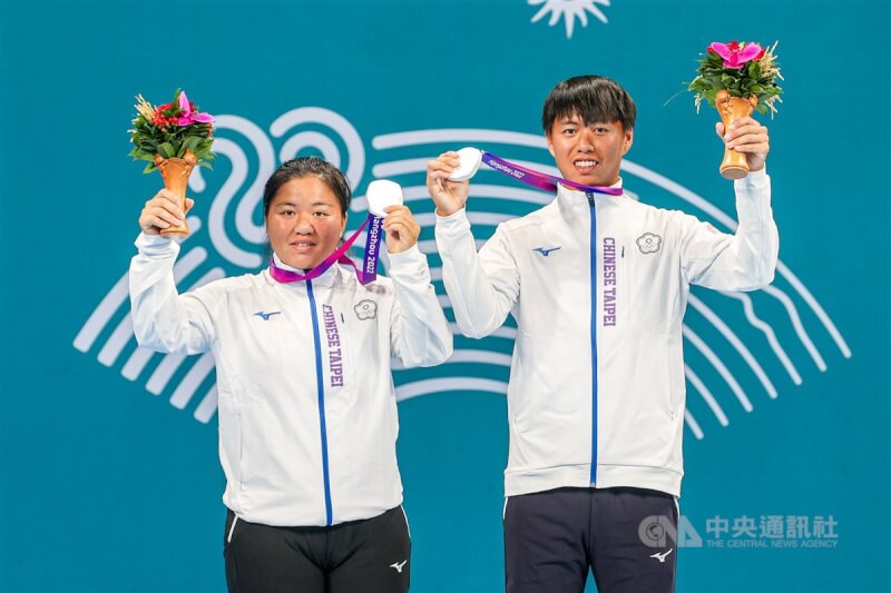 台灣網球好手黃琮豪(右)、梁恩碩(左)搭檔出征杭州亞運網球混雙賽事,30日在金牌戰雖不敵對手,仍為台灣再添一面銀牌,兩人賽後開心高舉獎牌合影。中央社 112年9月30日