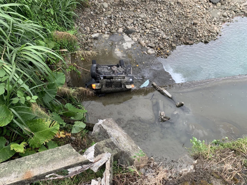 嘉義縣中埔鄉忠全橋4日發生小客車掉落橋下事故，1輛自小客車四輪朝天躺在溪床上，所幸車內駕駛意識清楚，自行脫困後送醫，但酒測值超標，警方將待駕駛出院後通知其到案說明。中央社記者蔡智明攝  112年10月4日