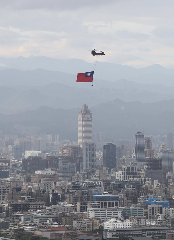 雙十國慶將至，國軍6日清晨展開國慶前最後一次空中全兵力預演，陸軍CH-47SD契努克運輸直升機懸掛巨幅國旗飛越台北市區上空，場面壯觀。中央社記者趙世勳攝 112年10月6日