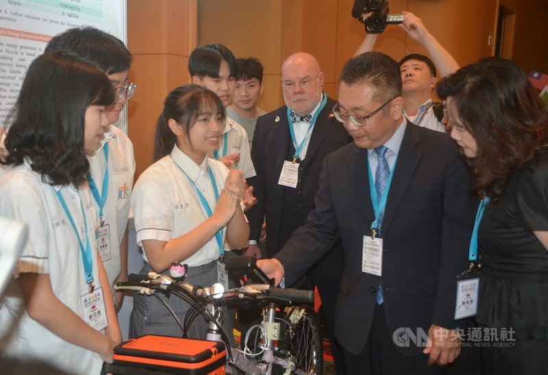 新北市2023年國際技職青年高峰論壇24日舉行,市府教育局副局長劉明超(前右2)等出席,聽取新北市立樟樹國際實創高級中等學校學生發表「綠能循環腳踏車」的介紹。中央社記者黃旭昇新北攝 112年10月24日