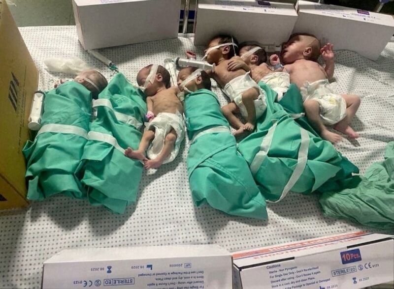 圖為12日加薩市西法醫院停電後，新生兒被從保溫箱中抱出後放在床上。（路透社）