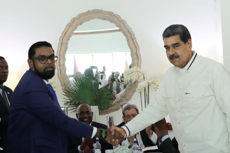 委內瑞拉總統馬杜洛（前右）和蓋亞那總統阿里（前左）14日在加勒比海國家聖文森及格瑞那丁舉行會議，兩人願意繼續對話以解決艾瑟奎波領土爭端，握手後達成協定。（Miraflores Palace/Handout via 路透社）