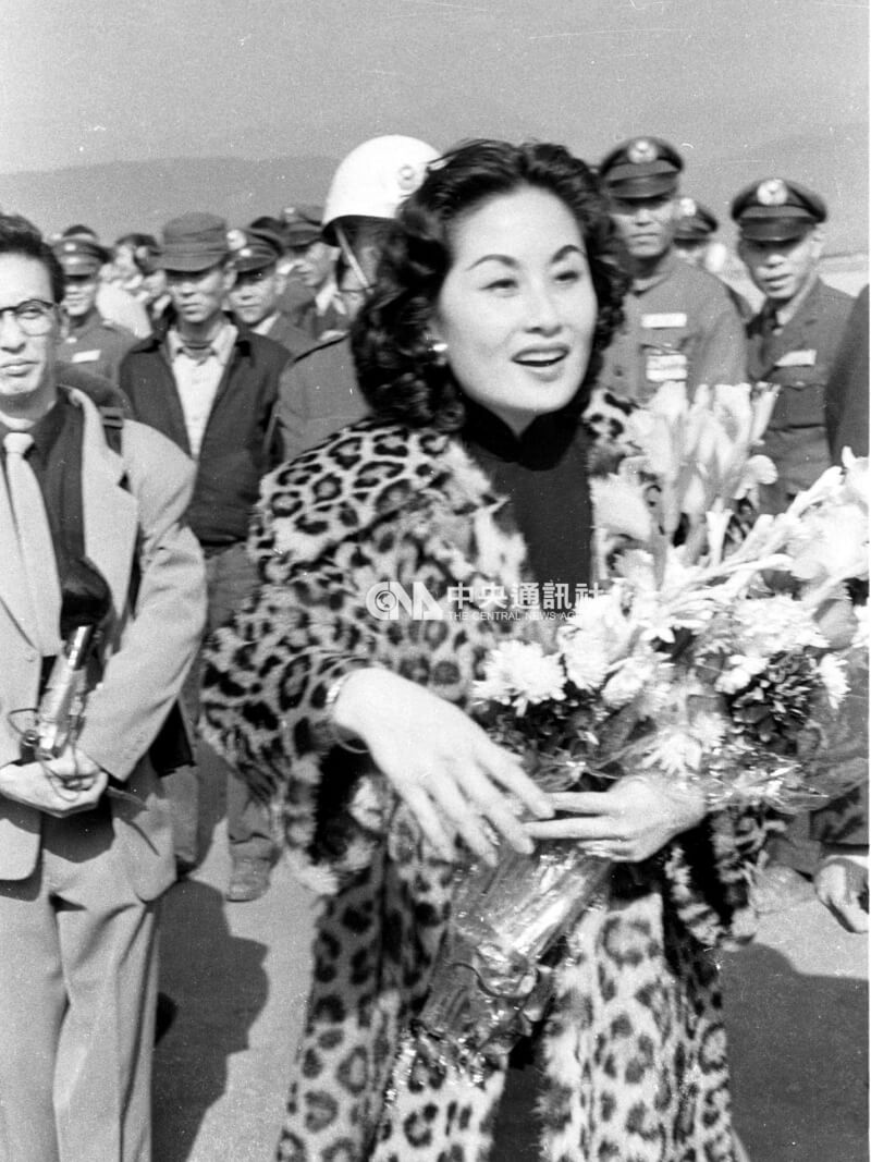 1958年12月白光下機後接受獻花與握手。她身穿一襲豹紋大衣，散發巨星丰采。（中央社檔案照片）