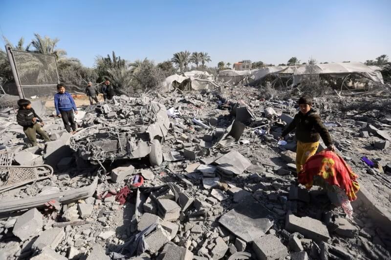 以色列與哈瑪斯之間衝突持續，巴勒斯坦人22日聚集在受損民宅附近。（路透社）