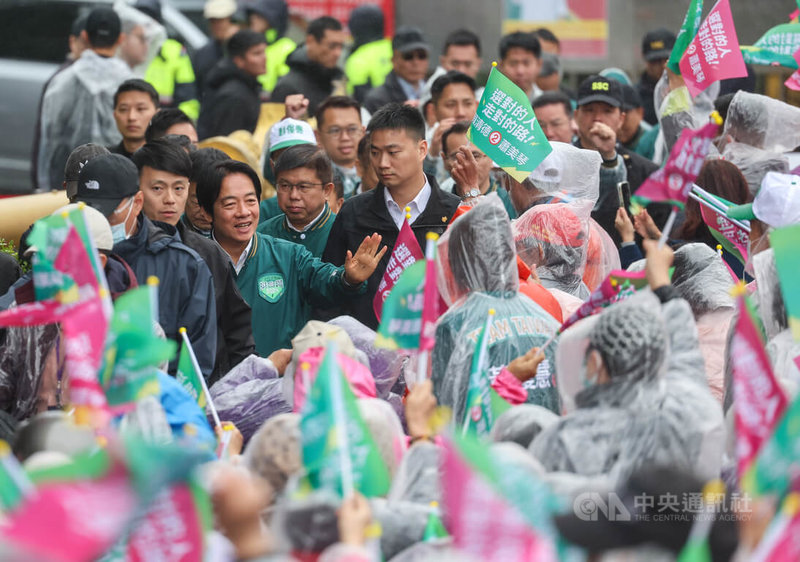 民進黨總統候選人賴清德（前左，綠衣）環島拼圖「唱土地的歌，拼咱的希望」24日進入最後一天，上午在桃園明倫三聖宮舉行桃園場活動，許多支持者冒雨到場力挺。中央社記者裴禛攝　112年12月24日