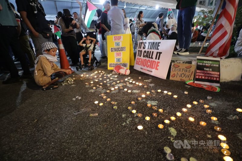 大馬社運團體在美國使館前集會跨年，在地面上以蠟燭排成「拯救加薩」字樣，希望喚起外界關注仍受砲火圍困的巴勒斯坦人民。中央社記者黃自強吉隆坡攝  113年1月1日