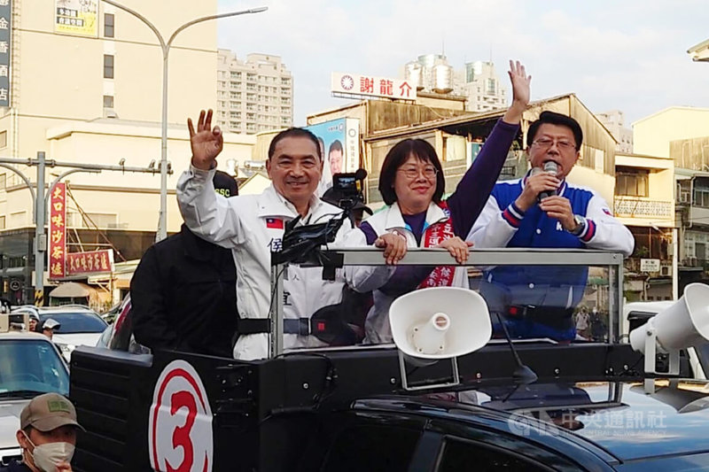 國民黨總統候選人侯友宜（車上，左）2日下午到台南進行車隊掃街拜票，在北區海安路競選總部前搭車出發，他比出3號手勢，懇託民眾支持。中央社記者楊思瑞攝  113年1月2日