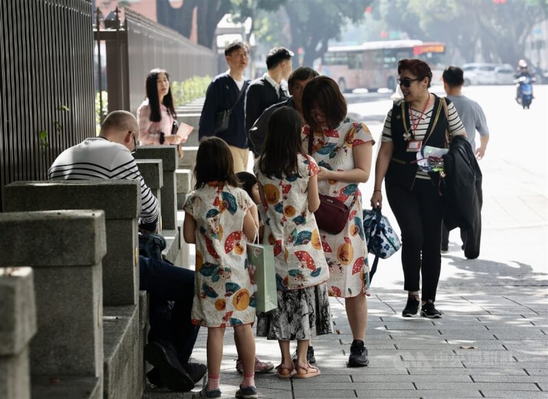 圖為氣溫回升，台北市中正區有民眾穿短袖親子裝外出。（中央社檔案照片）