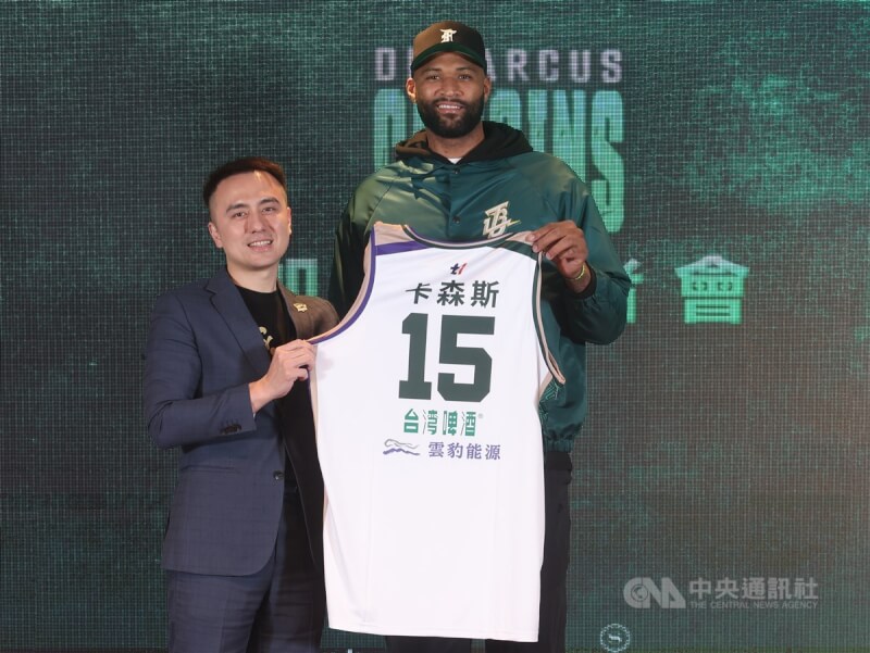 台灣職籃T1聯盟台啤永豐雲豹隊找來前美國職籃NBA球星卡森斯（DeMarcus Cousins，前譯柯森斯）（右）助陣，20日將在主場正式出賽，19日晚間球團先在桃園舉辦加盟記者會，雲豹執行長張建偉（左）會中送上15號球衣。中央社記者張新偉攝 113年1月19日